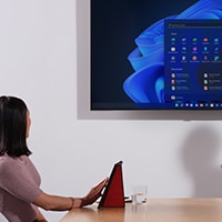 woman looking at desktop on big screen television