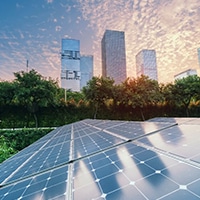 Solar panels with high rises in the background
